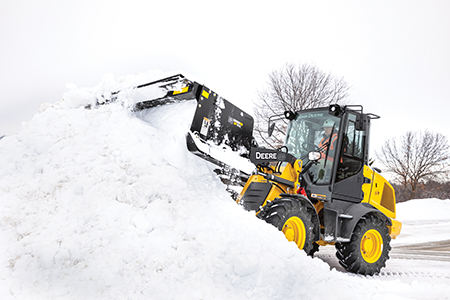 SP10C pushing snow attached to the 244L Compact Wheel Loaders