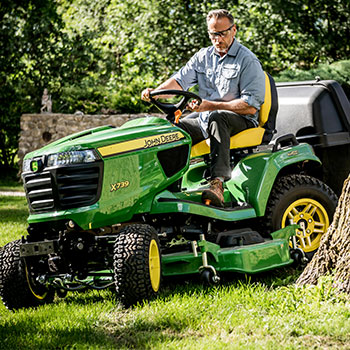 X739 Tractor trimming around a tree