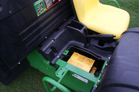 Battery charger located under passenger seat