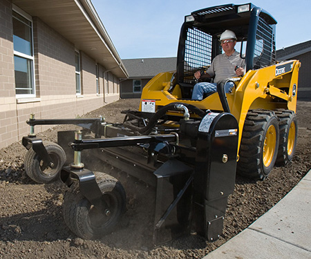 313 Skid Steer with power rake attachment