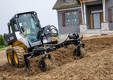 324G Skid Steer with power rake attachment