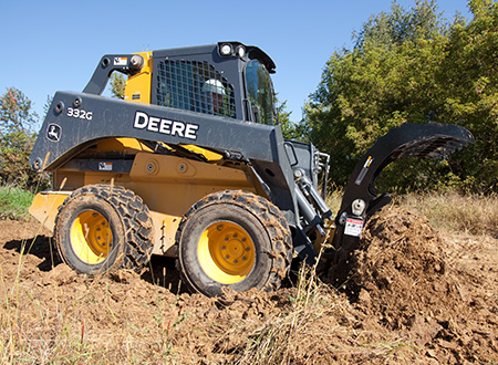 332G Skid Steer with root rake attachment