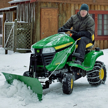 44-in. (112-cm) Front Blade, electric lift, angling and tire chains on an X350 Tractor