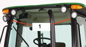 Auxiliary work light kit (1) on front of a 5M cab