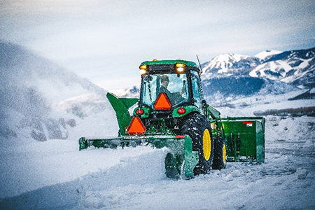 4R tractor operating in snow conditions